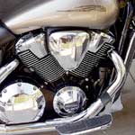 Aside from size, the VTX 1800's engine is an almost typical Honda cruiser V-twin. That is, it employs Shadow-like technology in the split crankpins—the connecting rods meet the crank at two slightly skewed positions, not side by side as on the other V-twins here—which helps reduce vibration significantly. (Split pins create other types of vibration in smaller amounts, but aren't nearly as annoying as the large primary imbalance of a narrow-angle—in this case 52-degree—V-twin.) This scheme makes the engine act more like a 90-degree V-twin, which has perfect primary balance. What vibration escapes the split crankpins and the massive, 41-pound flywheel assembly is counteracted by a gear-driven counterbalancer, while driveline shocks are taken up by three sets of dampers, one on the crank end and two in the clutch. Twin-plug combustion chambers are fed by three valves each, two intake and one exhaust, long a Honda hallmark for engines intended to produce little high-rpm power. Unlike the Kawasaki and Yamaha, the Honda uses chain-driven single overhead cams. Generous cooling fins suggest otherwise, but the VTX is in fact liquid-cooled. If you're wondering, the actual redline is 5750 rpm.